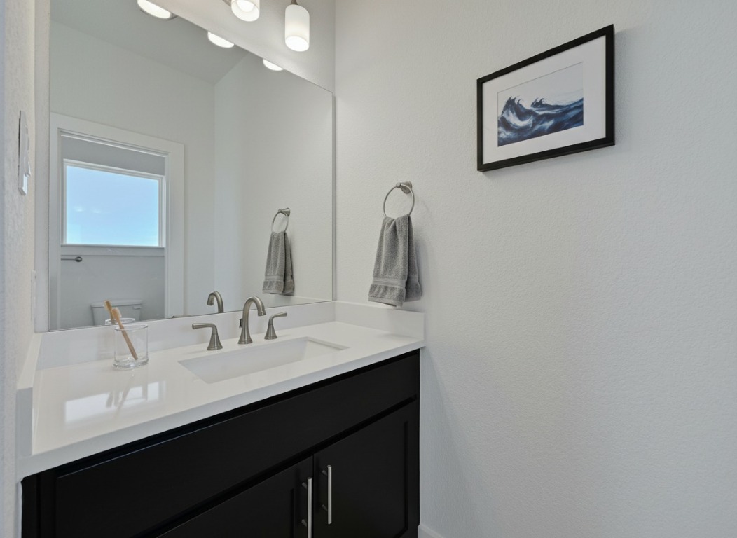 904 Arundel Road Lakeway, TX 78738 - Photo 12 of 40 a bathroom with a sink and a mirror