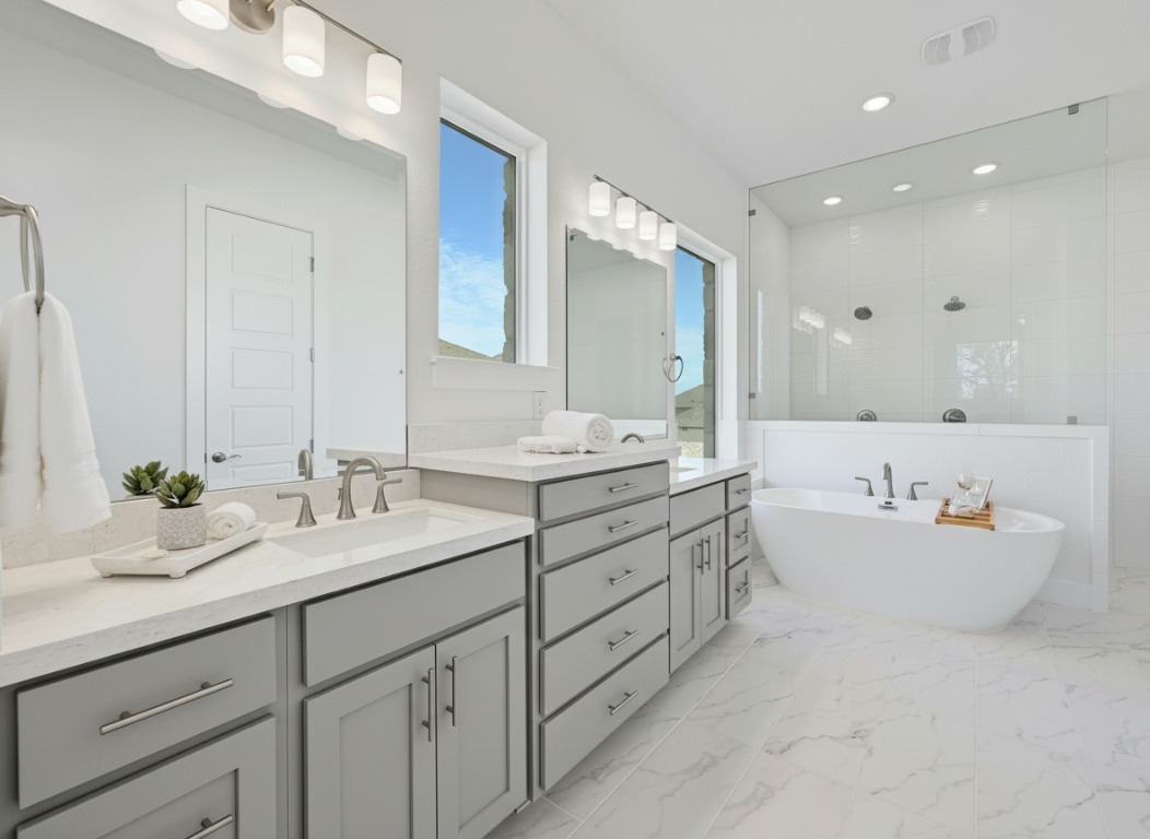 904 Arundel Road Lakeway, TX 78738 - Photo 14 of 40 a bathroom with a double vanity sink mirror and bathtub