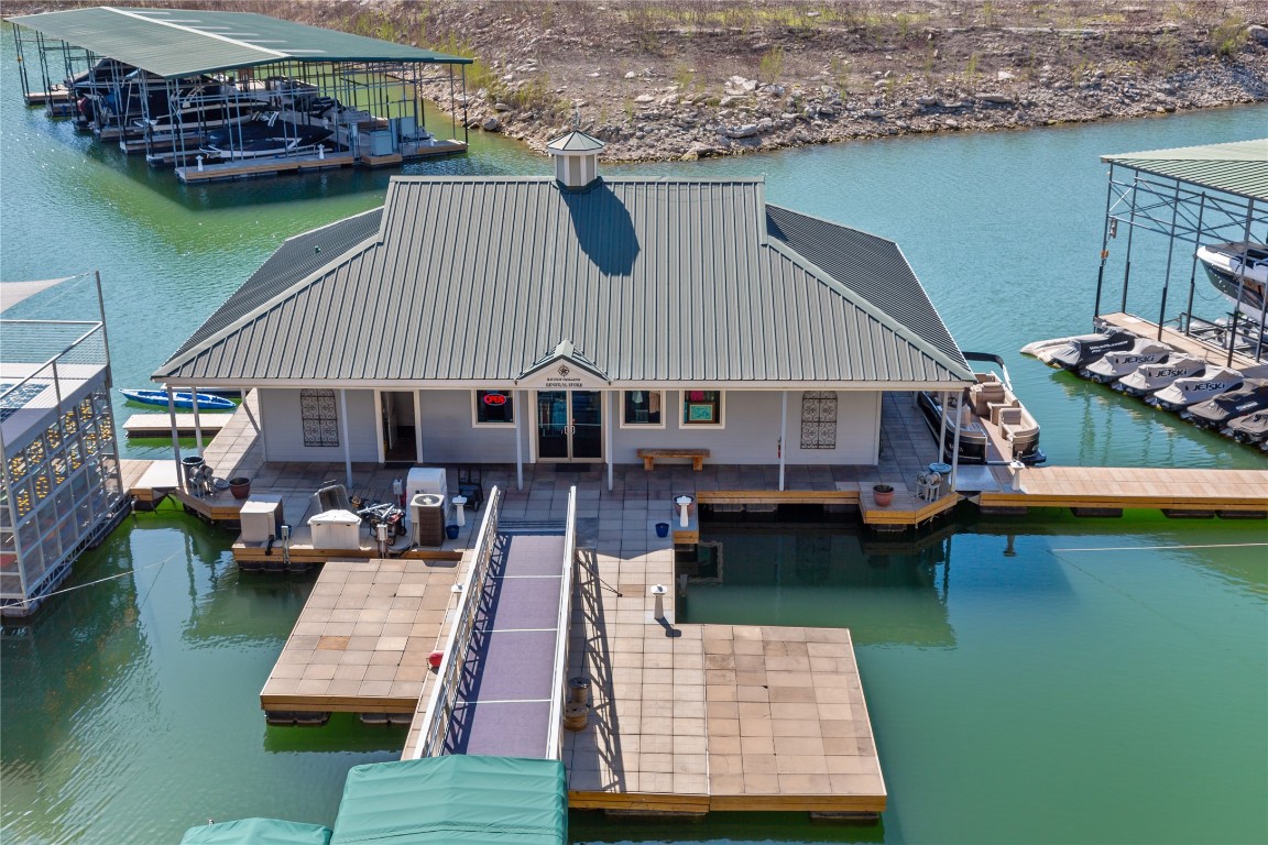 904 Arundel Road Lakeway, TX 78738 - Photo 32 of 40 a aerial view of a house roof deck with table and chairs