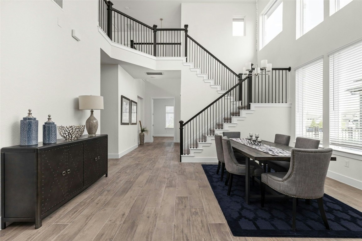 904 Arundel Road Lakeway, TX 78738 - Photo 4 of 40 a dining room with furniture and wooden floor