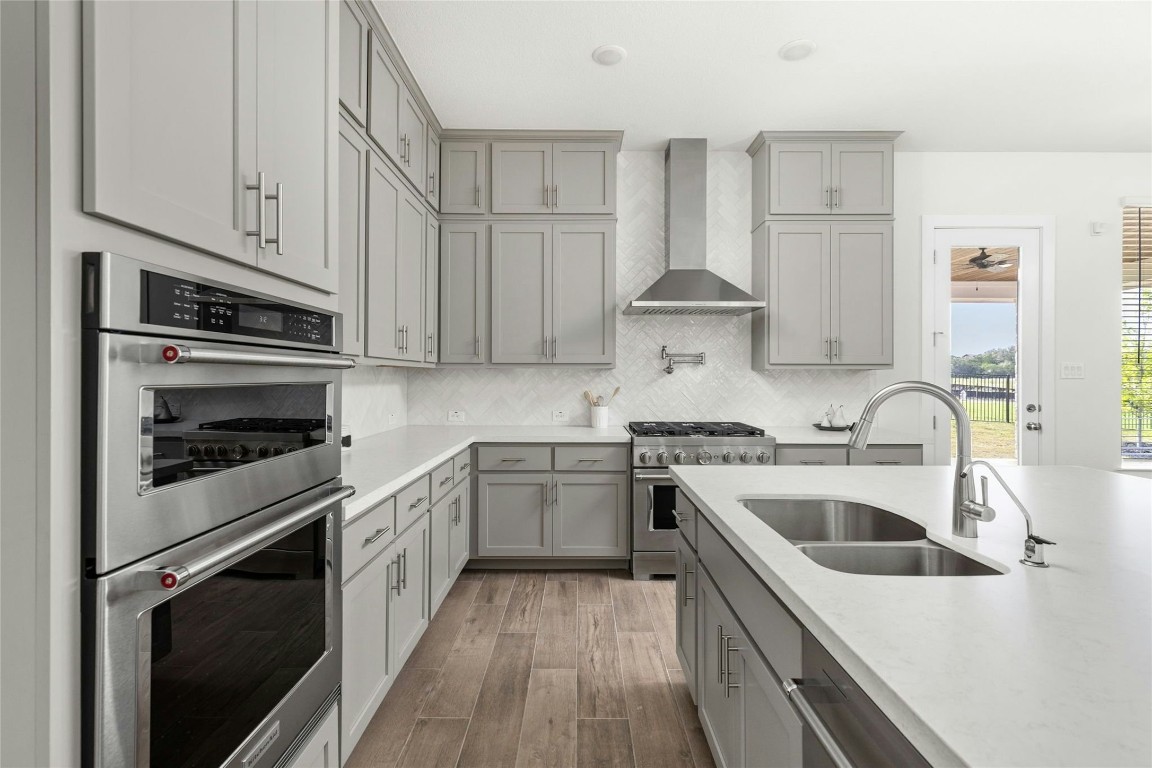 904 Arundel Road Lakeway, TX 78738 - Photo 8 of 40 a kitchen with stainless steel appliances granite countertop a sink stove and cabinets