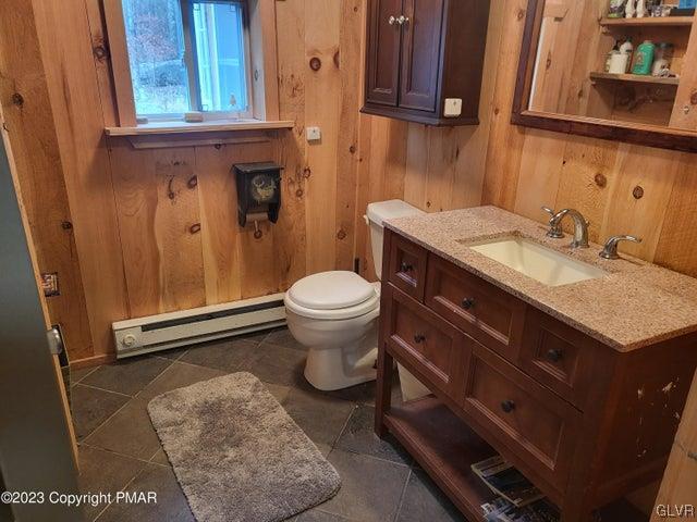 125 Ness Road Dingmans Ferry, PA 18328 - Photo 15 of 29 a bathroom with a granite countertop toilet sink and mirror