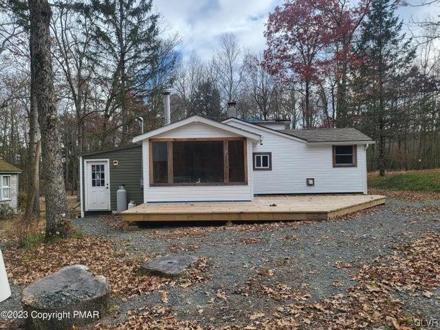 125 Ness Road Dingmans Ferry, PA 18328 - Photo 2 of 29 a front view of a house with a garden