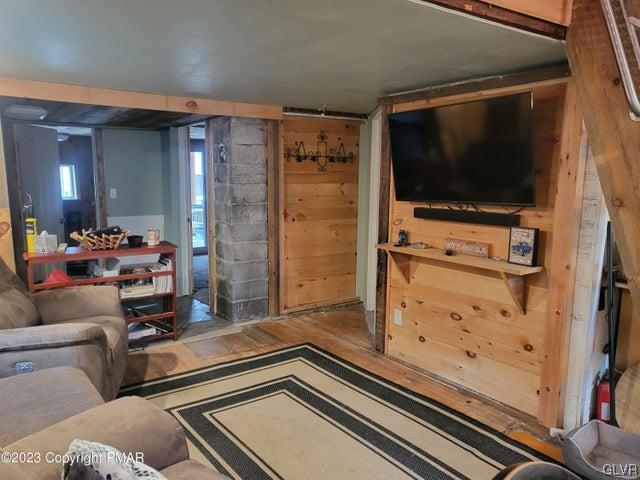 125 Ness Road Dingmans Ferry, PA 18328 - Photo 4 of 29 a room with furniture and a flat screen tv