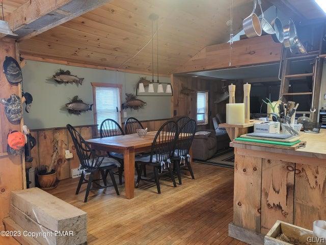 125 Ness Road Dingmans Ferry, PA 18328 - Photo 5 of 29 a view of a dining room with furniture window and wooden floor