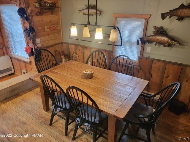 125 Ness Road Dingmans Ferry, PA 18328 - Photo 6 of 29 a dining room with furniture and wooden floor
