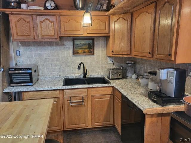125 Ness Road Dingmans Ferry, PA 18328 - Photo 10 of 29 a kitchen with stainless steel appliances granite countertop a sink and cabinets