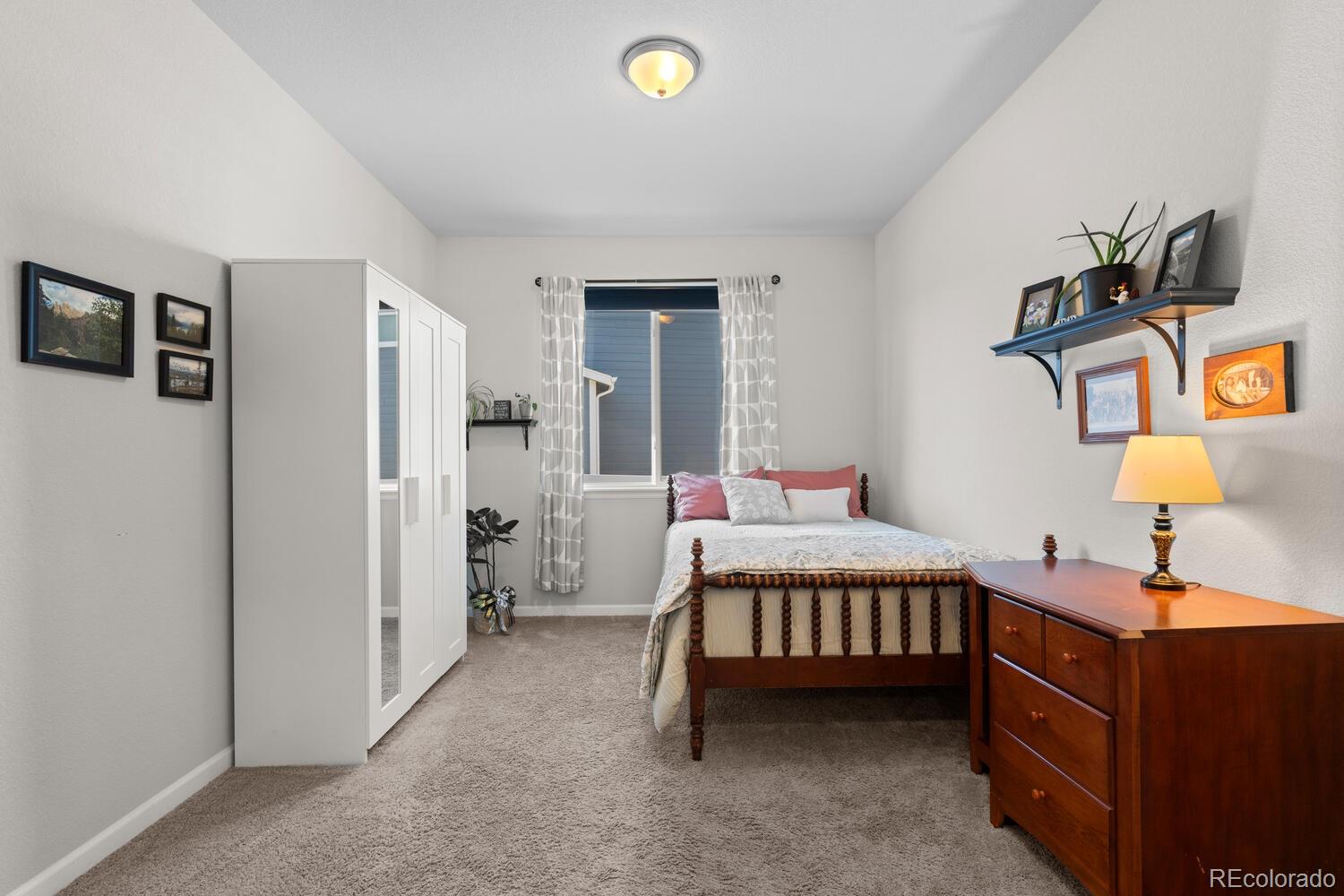 1587 Lake Point Way Severance, CO 80550 - Photo 13 of 40 a bedroom with a bed and a chandelier