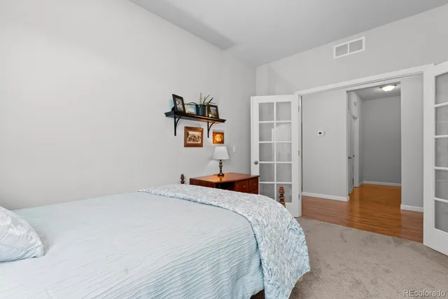 a kitchen with stainless steel appliances granite countertop a stove top oven a sink dishwasher a dining table and chairs with wooden floor