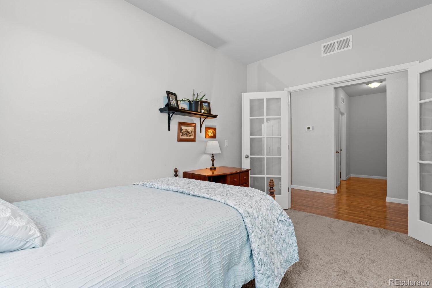 1587 Lake Point Way Severance, CO 80550 - Photo 14 of 40 a bedroom with a bed and a painting on the wall