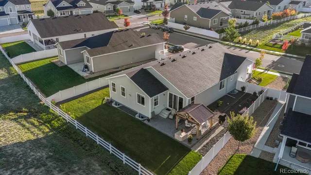 an aerial view of a house with a garden and trees