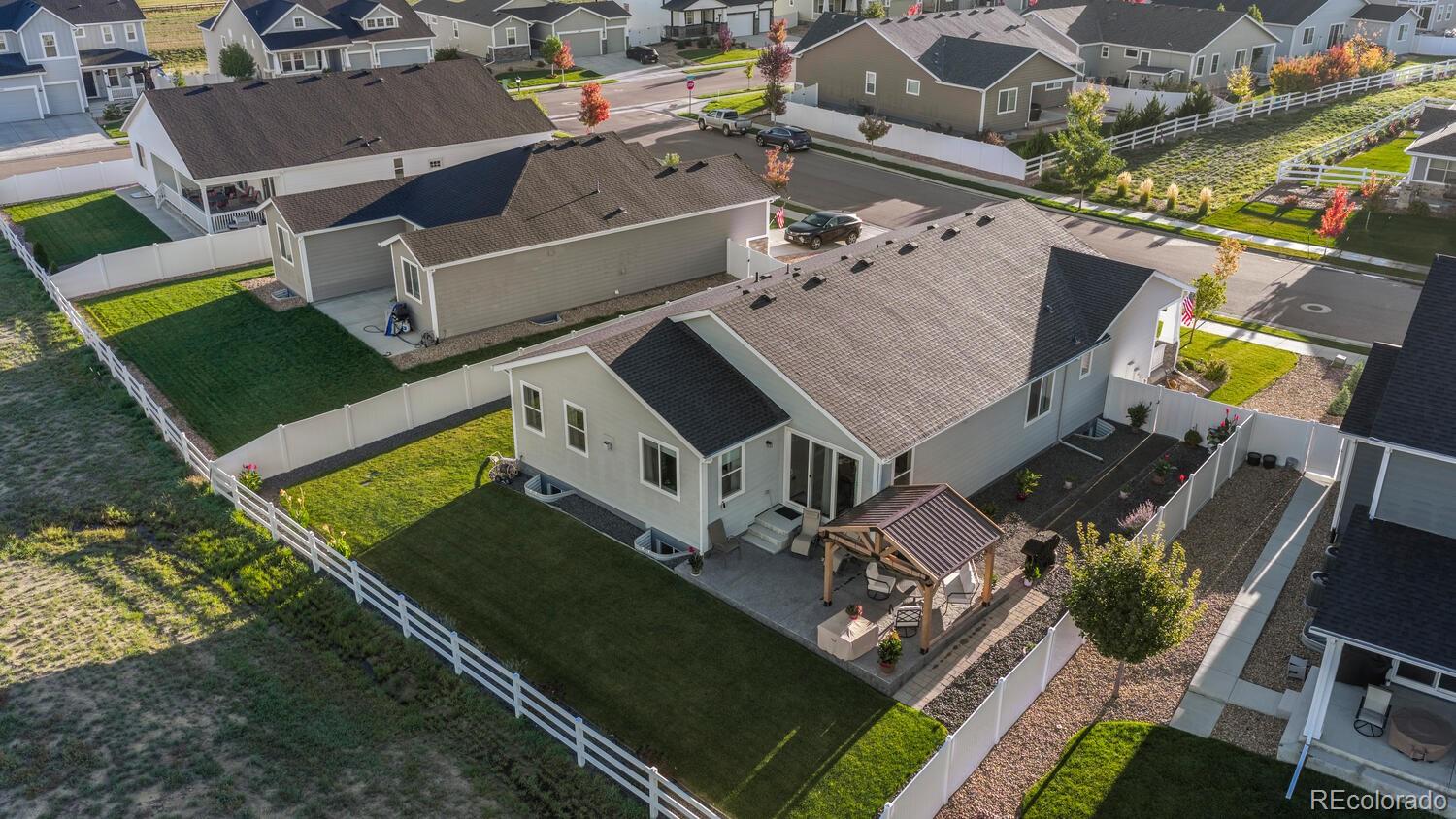 1587 Lake Point Way Severance, CO 80550 - Photo 2 of 40 an aerial view of a house with a garden and trees