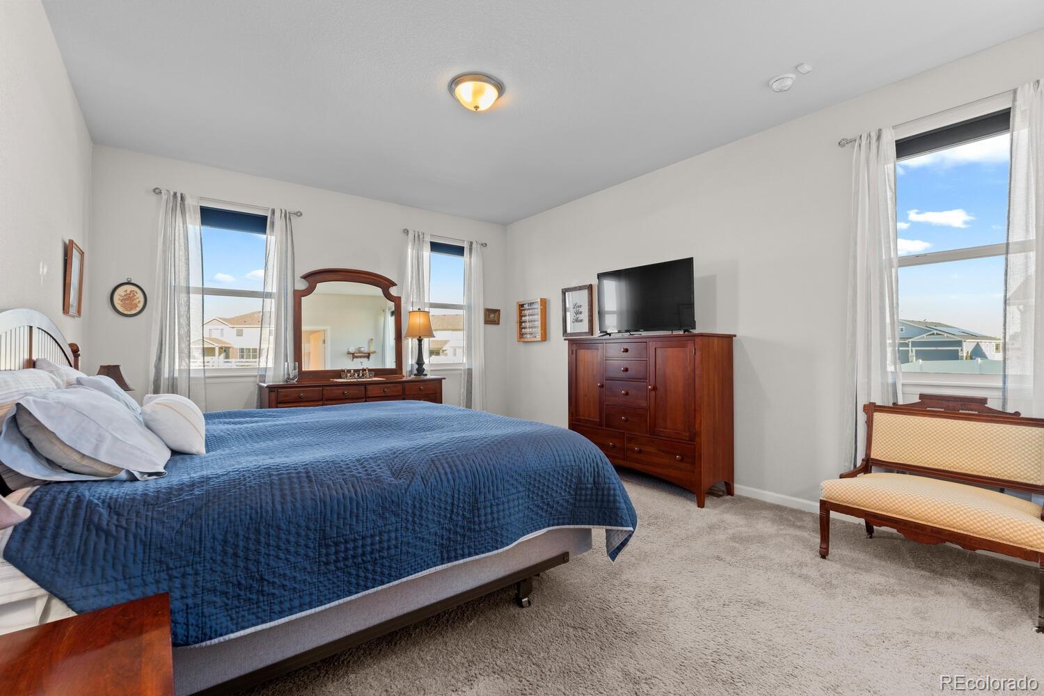 1587 Lake Point Way Severance, CO 80550 - Photo 23 of 40 a bedroom with a bed and a flat screen tv
