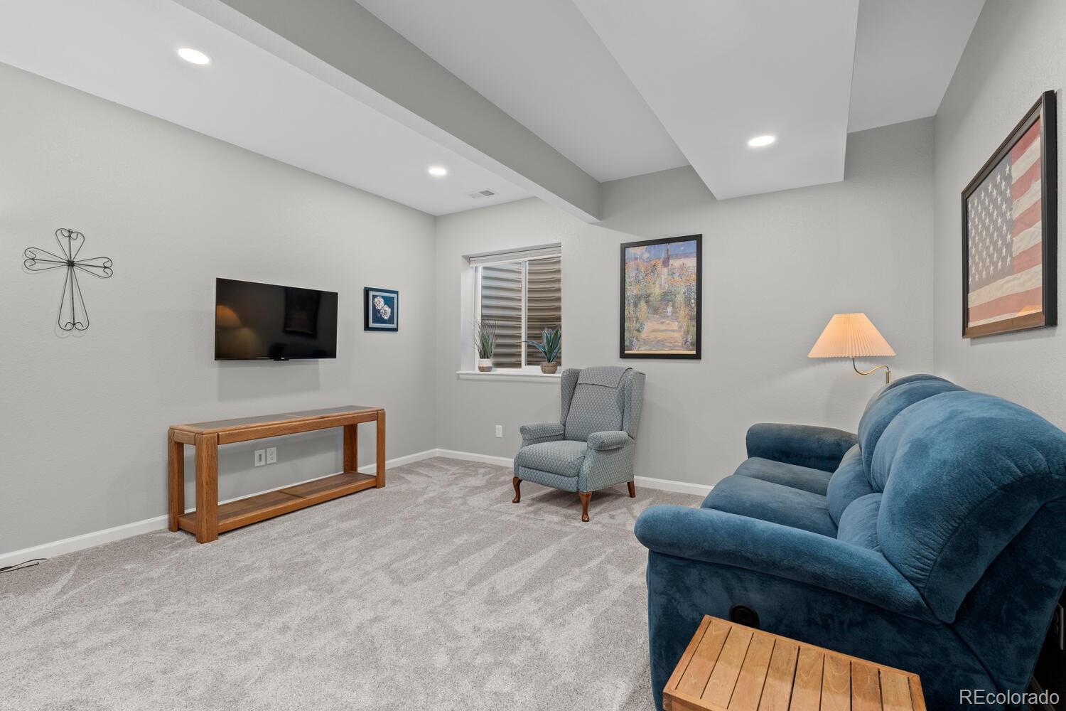 1587 Lake Point Way Severance, CO 80550 - Photo 29 of 40 a living room with furniture and a flat screen tv