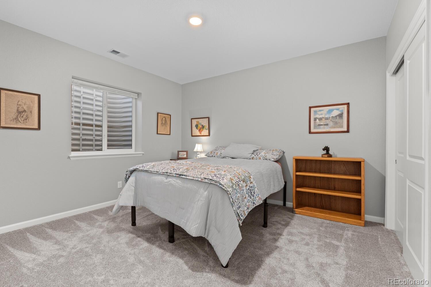 1587 Lake Point Way Severance, CO 80550 - Photo 30 of 40 a bedroom with a bed and a window