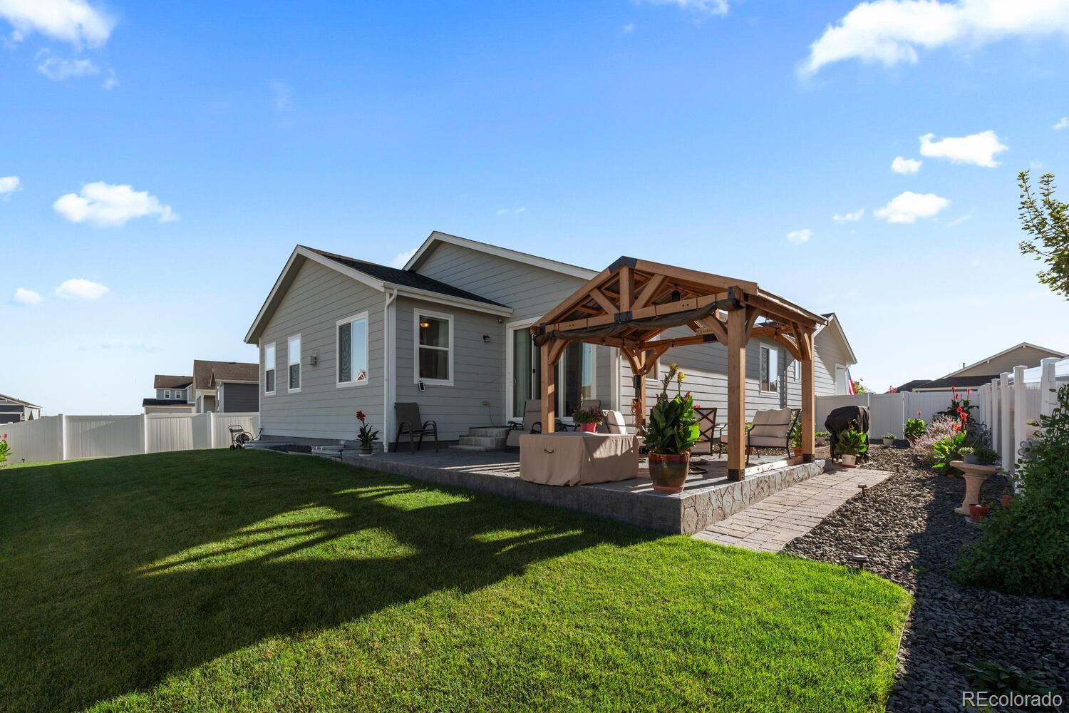 1587 Lake Point Way Severance, CO 80550 - Photo 35 of 40 a view of a house with backyard and sitting area