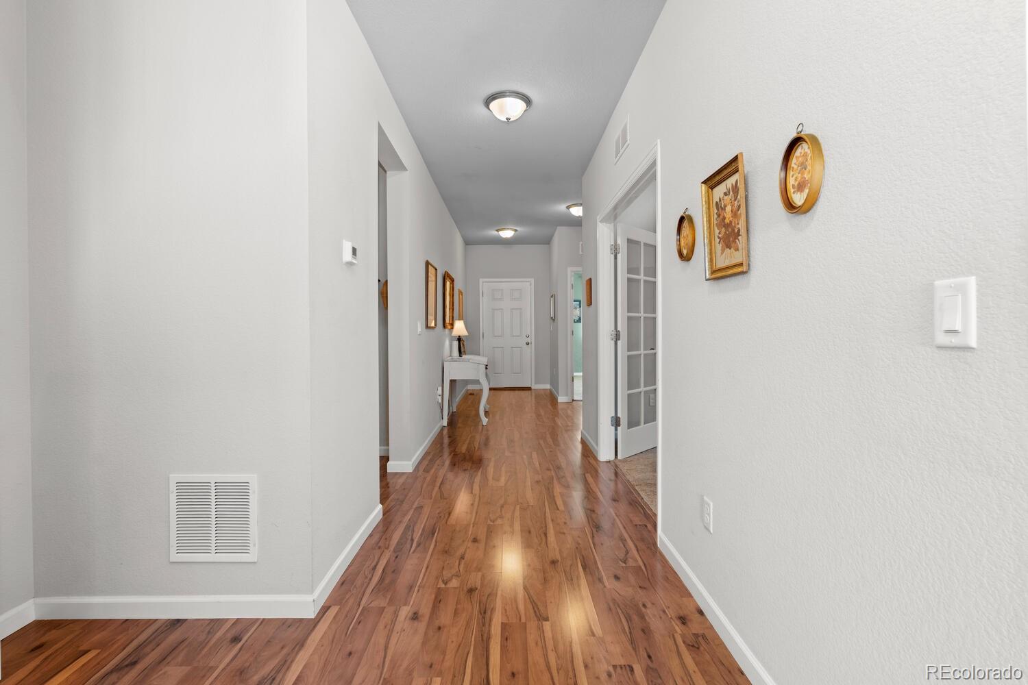 1587 Lake Point Way Severance, CO 80550 - Photo 8 of 40 a view of a hallway with wooden floor
