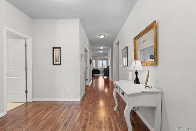 a bathroom with a sink a toilet a mirror and shower