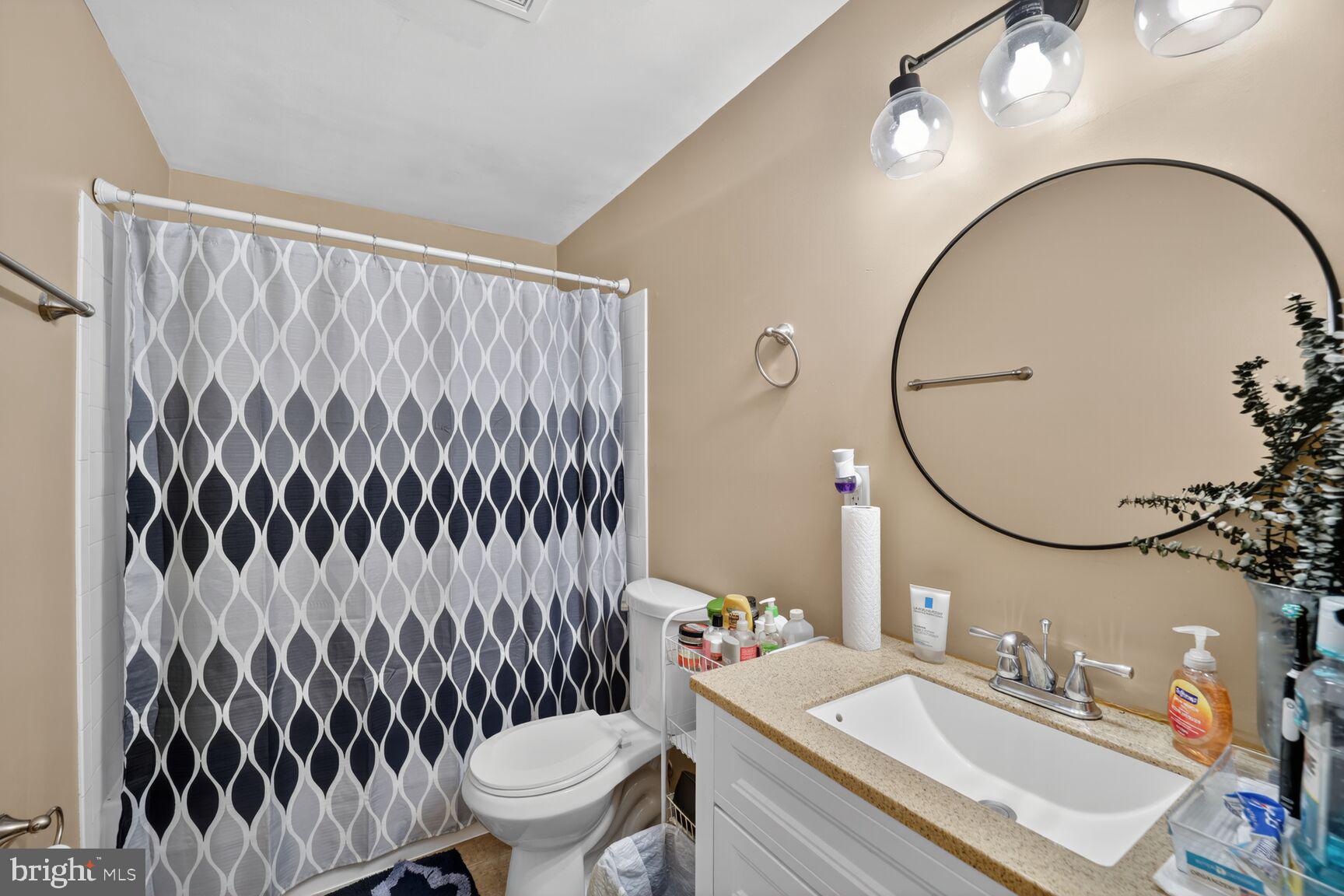 12611 Windbrook Drive Clinton, MD 20735 - Photo 13 of 32 a bathroom with a sink toilet and a mirror