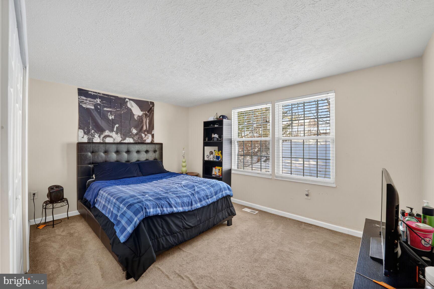 12611 Windbrook Drive Clinton, MD 20735 - Photo 14 of 32 a bedroom with a bed and a window with chair