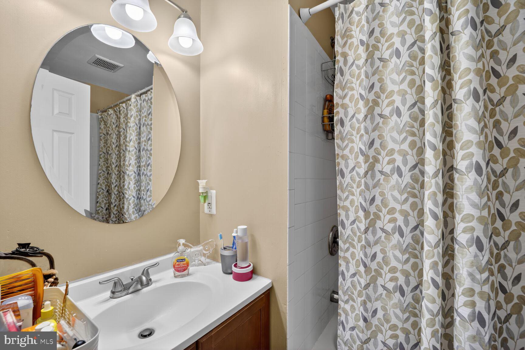 12611 Windbrook Drive Clinton, MD 20735 - Photo 20 of 32 a bathroom with a sink vanity and a mirror