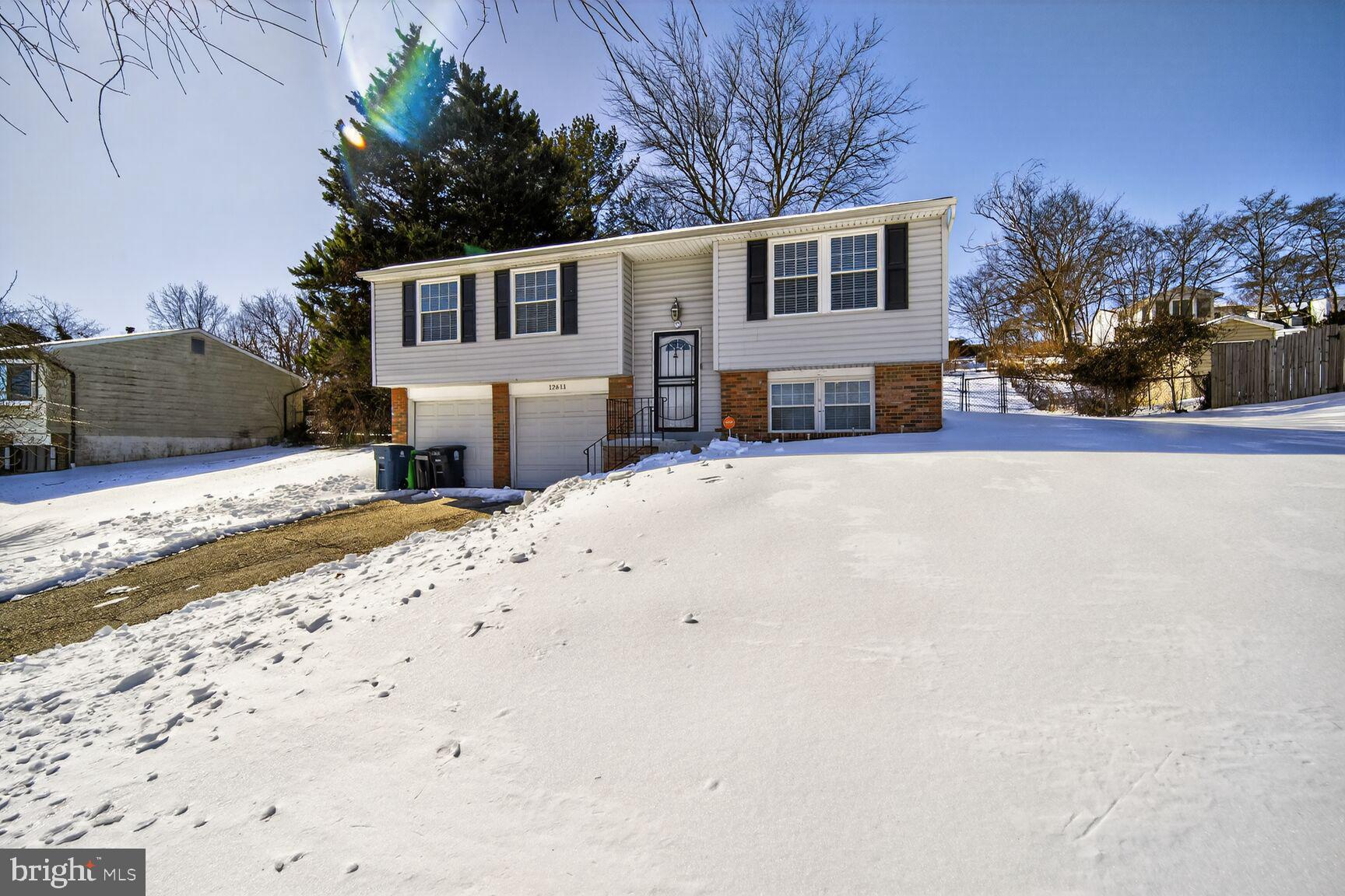 12611 Windbrook Drive Clinton, MD 20735 - Photo 2 of 32 a front view of a house with a yard