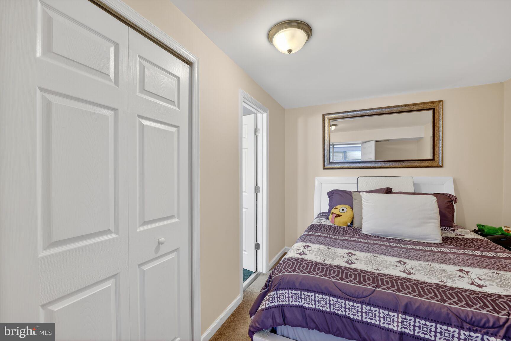 12611 Windbrook Drive Clinton, MD 20735 - Photo 21 of 32 a bedroom with a bed and wooden floor