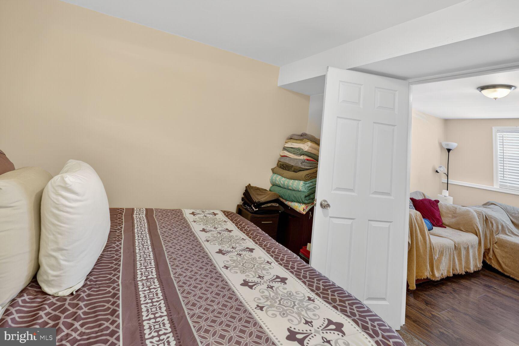 12611 Windbrook Drive Clinton, MD 20735 - Photo 24 of 32 a bedroom with a bed and wooden floor