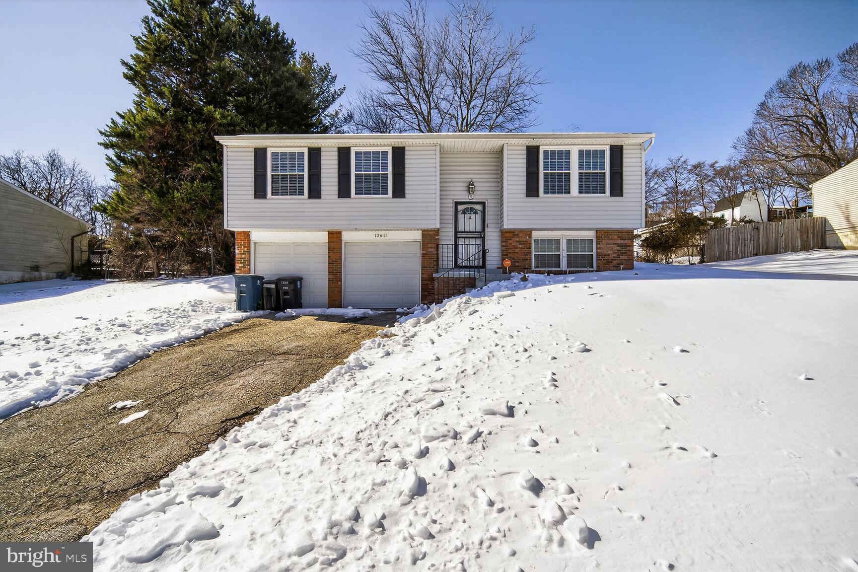 12611 Windbrook Drive Clinton, MD 20735 - Photo 29 of 32 a front view of a house with a yard covered in snow