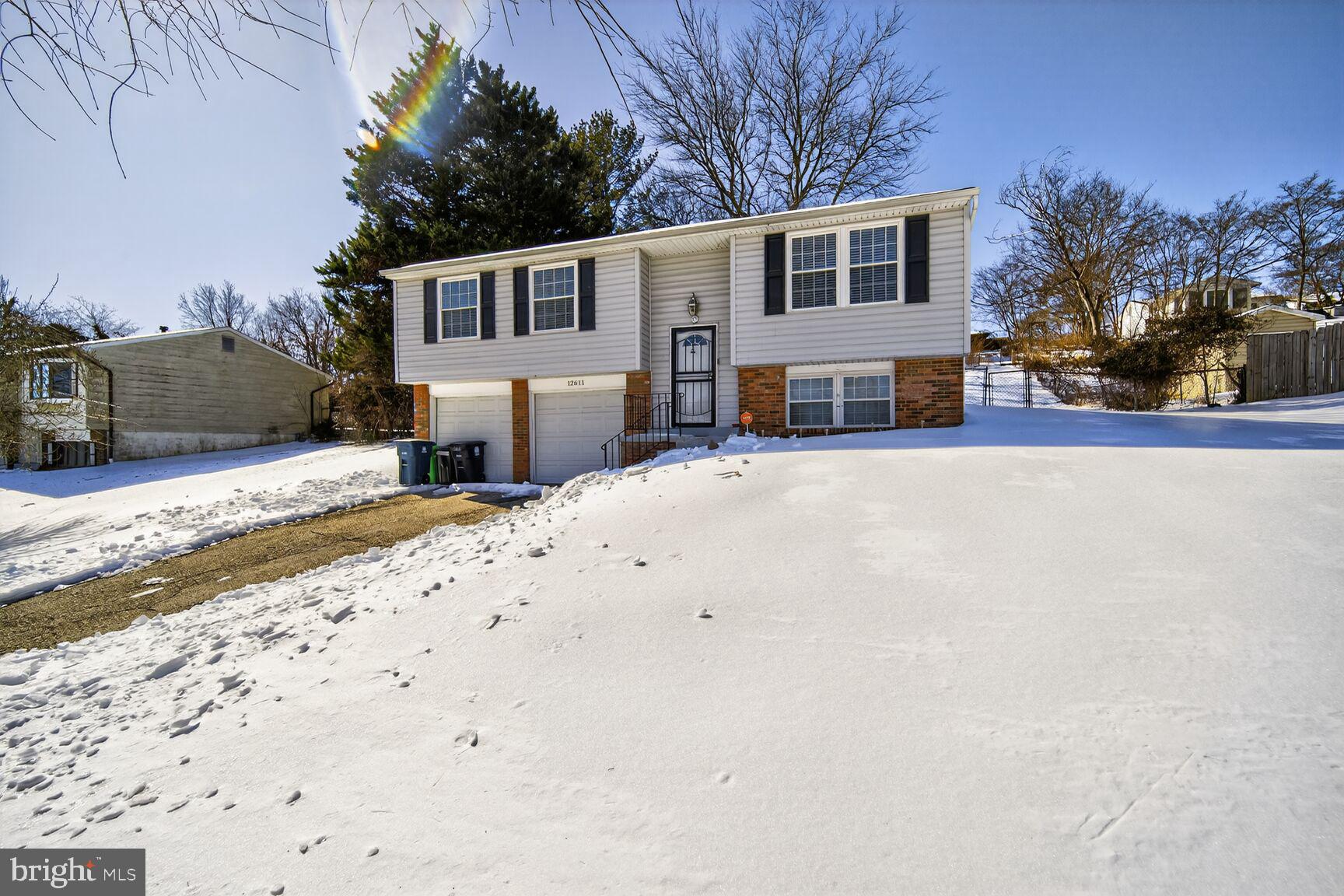 12611 Windbrook Drive Clinton, MD 20735 - Photo 3 of 32 a front view of a house with a yard and garage