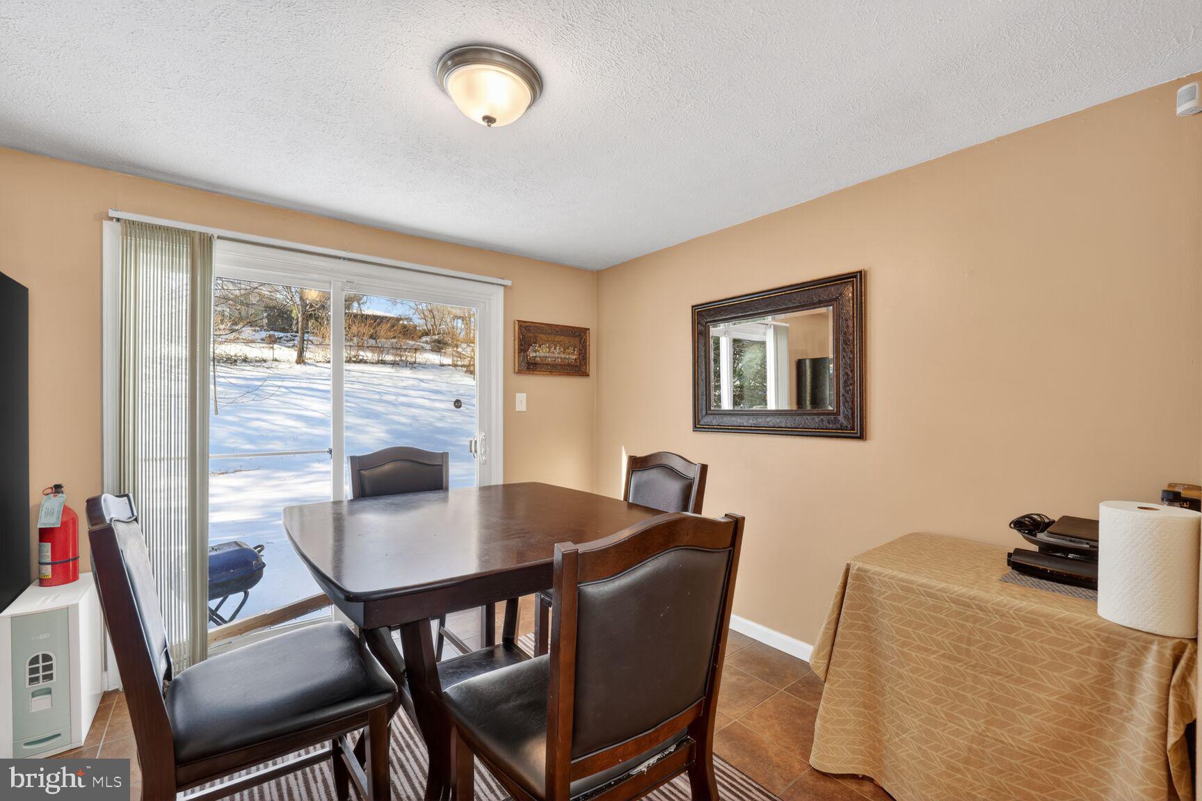 12611 Windbrook Drive Clinton, MD 20735 - Photo 7 of 32 a view of a dining room with furniture and a large window