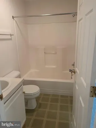 a bathroom with a shower and a toilet
