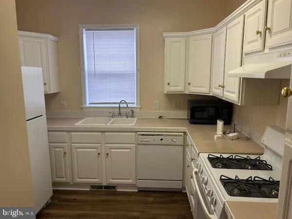 a kitchen with stainless steel appliances a stove a sink and a refrigerator