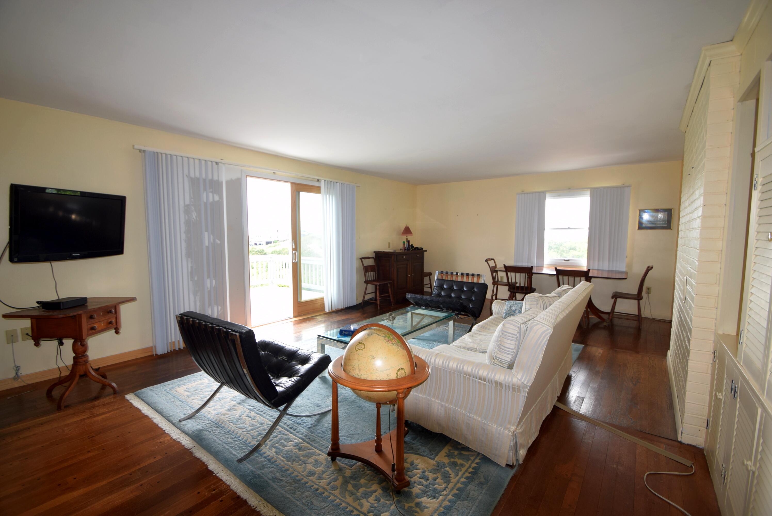 2 Ryder Hollow Road Truro, MA 02666 - Photo 14 of 31 a living room with furniture a flat screen tv and a large window