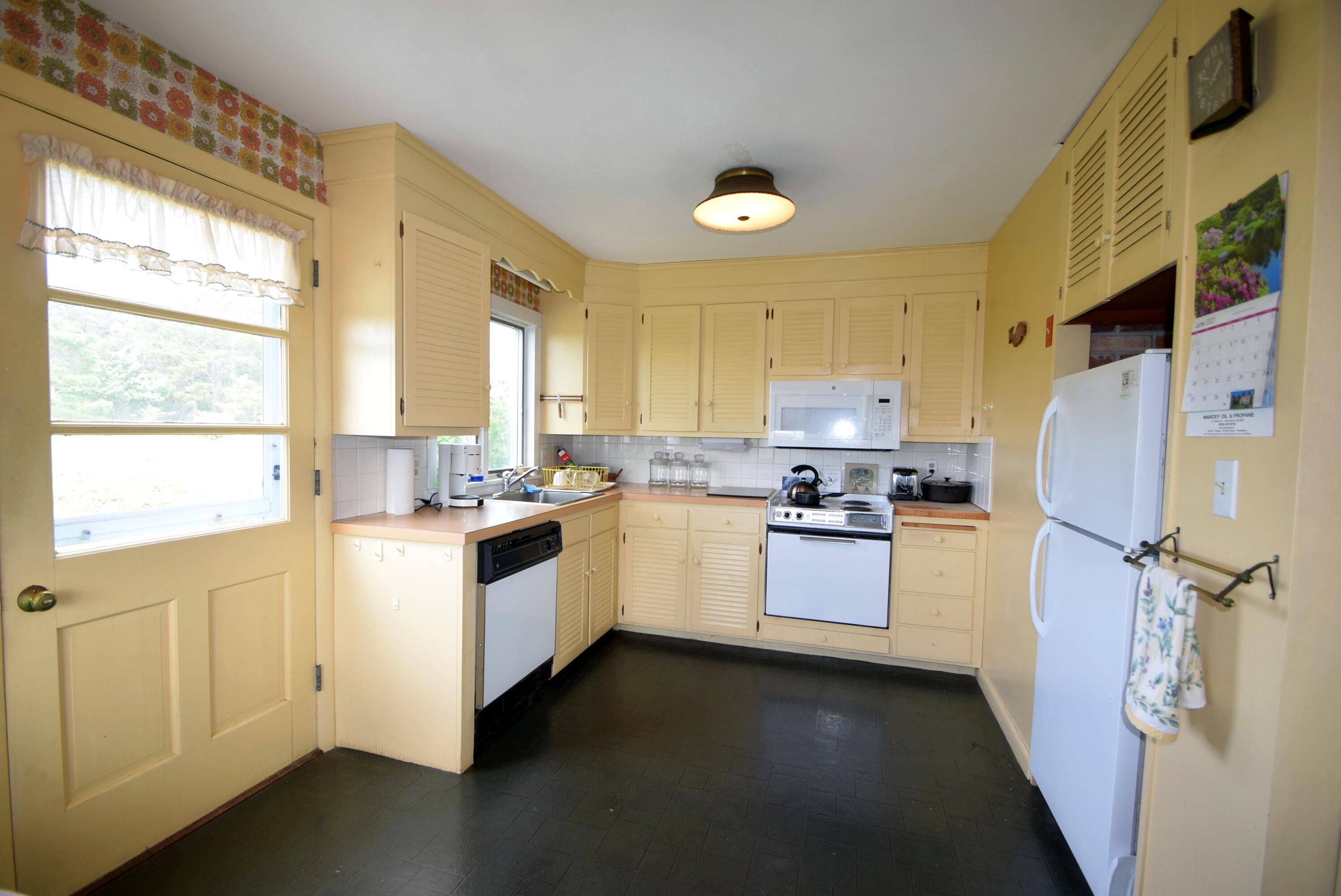 2 Ryder Hollow Road Truro, MA 02666 - Photo 17 of 31 a kitchen with a refrigerator a sink and cabinets