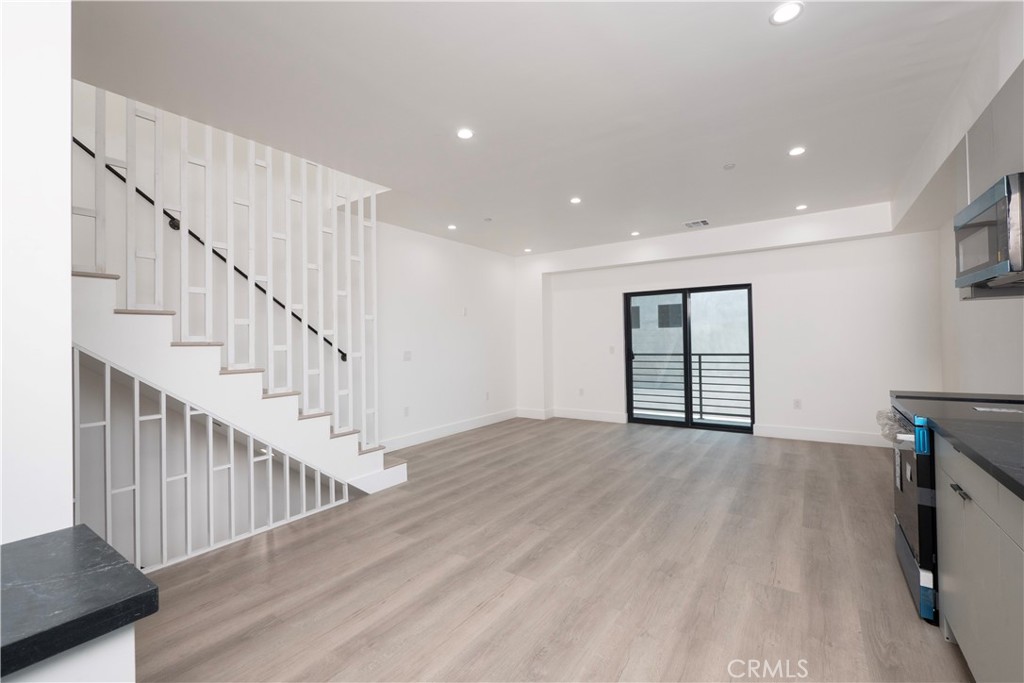 1571 Ricardo Street Los Angeles, CA 90033 - Photo 6 of 29 a view of an empty room with wooden floor and stairs