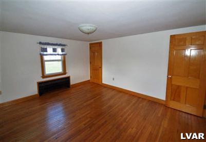 978 Bushkill Center Road Nazareth, PA 18064 - Photo 8 of 11 an empty room with wooden floor and windows