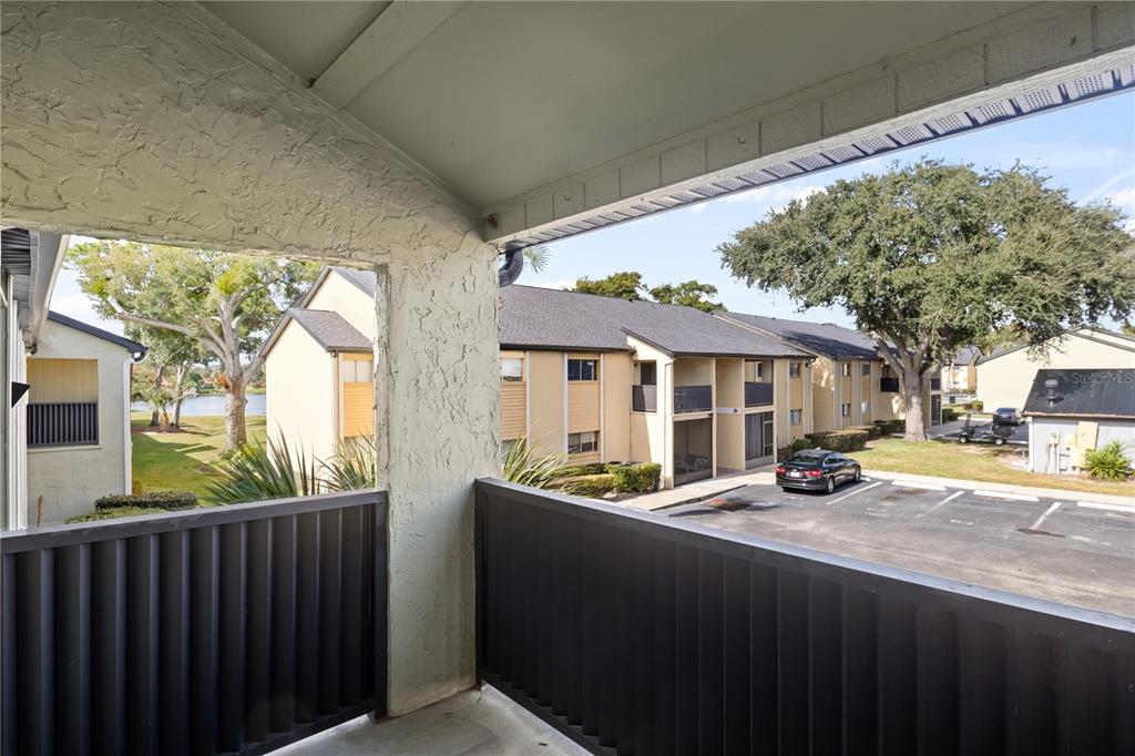 920 Lake Destiny Road, Unit F Altamonte Springs, FL 32714 - Photo 12 of 27 a view of a patio with table and chairs under an umbrella with a large tree