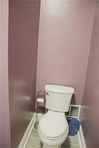 a white toilet sitting next to a shower