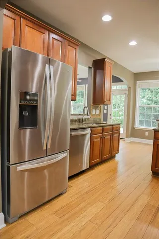 a kitchen with stainless steel appliances a refrigerator sink and cabinets