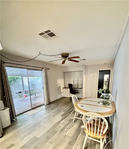 a room with wooden floor and pool table