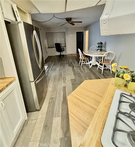 a view of a kitchen with furniture and a refrigerator