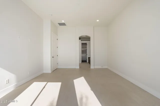 an empty room with windows and entrance