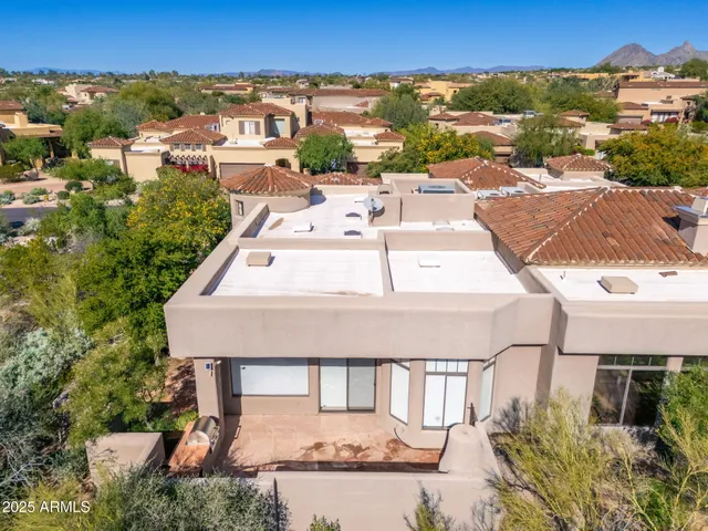 an aerial view of a residential houses with city view
