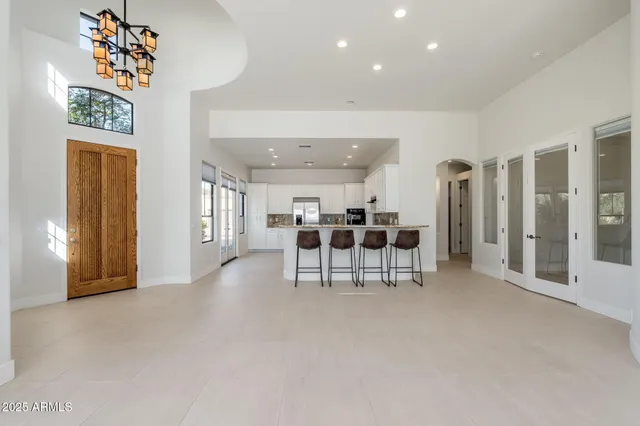 a front view of a house with a yard and potted plants