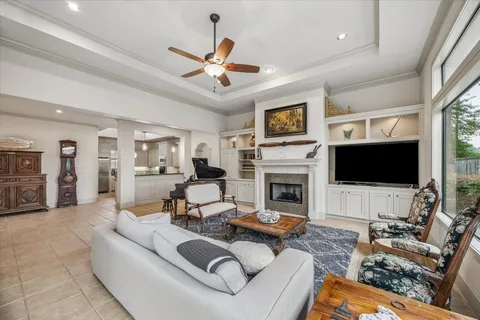 a living room with furniture a flat screen tv and a fireplace