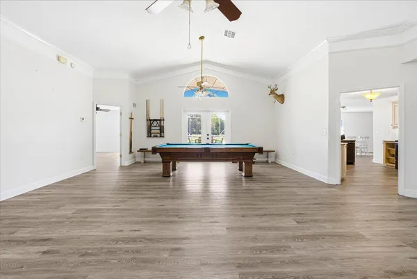 a view of a room with wooden floor fireplace and windows