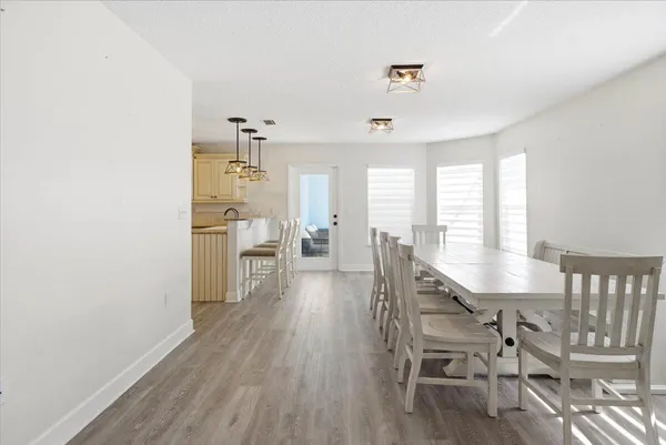 a dining room with furniture and wooden floor