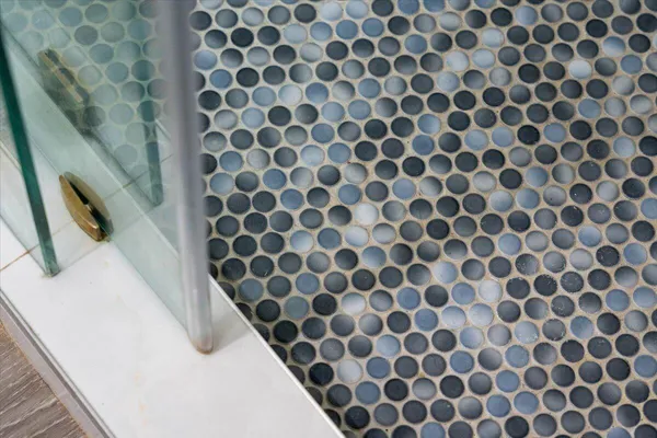 a bathroom with a black and white checkered floor
