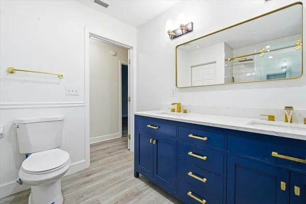 a bathroom with a sink and two mirror